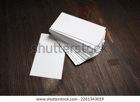 Blank white business cards on wooden background. Mockup for ID. Template for graphic designers portfolios.