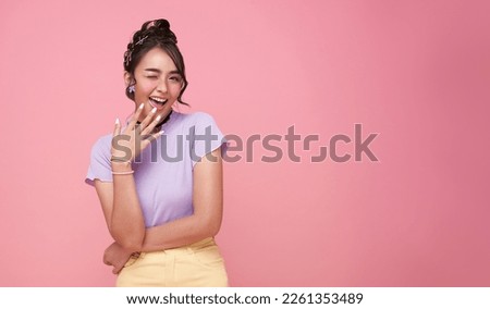 Young Asian teenage girl surprised excited isolated on pink background. Royalty-Free Stock Photo #2261353489