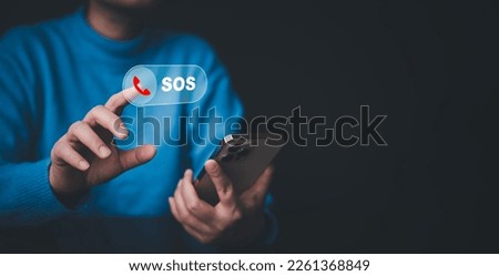 Businessman touch bar SOS Emergency app in home, call phone, Chat message icon, Emergency application from smartphone for elderly, technology concept.Old hand touch mobile phone and call for help. Royalty-Free Stock Photo #2261368849