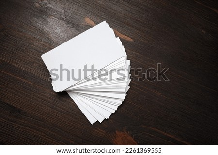 Blank business cards on wooden background. Mockup for branding identity. Template for graphic designers portfolios. Flat lay.