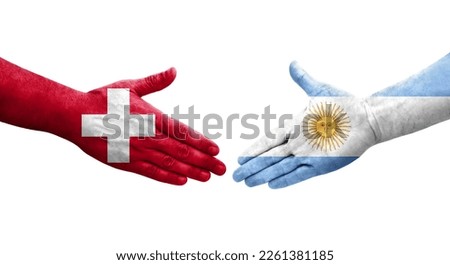 Handshake between Switzerland and Argentina flags painted on hands, isolated transparent image.