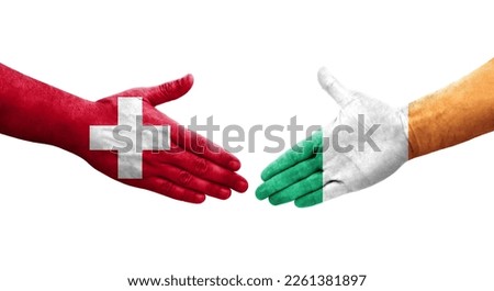 Handshake between Switzerland and Ireland flags painted on hands, isolated transparent image.