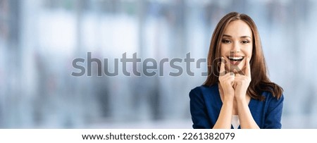 Dental dent health care concept picture - happy excited beautiful woman in blue cloth show white toothy smile. Portrait image of brunette girl, blurred interior, lab background, wide banner copy space