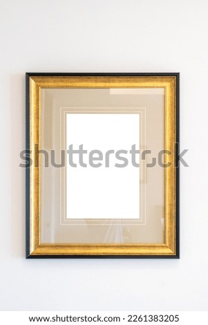 Blank golden vintage wood picture photo frame on white wall background
