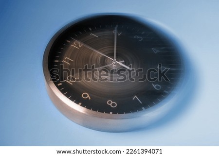 Fleeting time concept. Clock on light blue background, motion effect