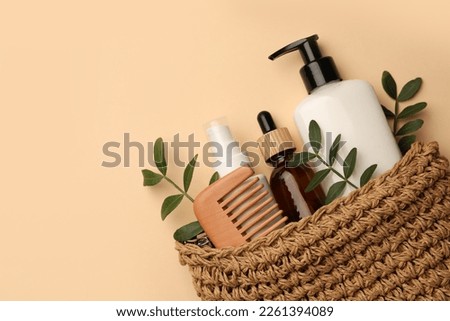 Preparation for spa. Compact toiletry bag with different cosmetic products on beige background, flat lay. Space for text Royalty-Free Stock Photo #2261394089