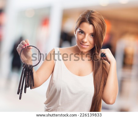 portrait of a cute girl holding a bunch of old keys