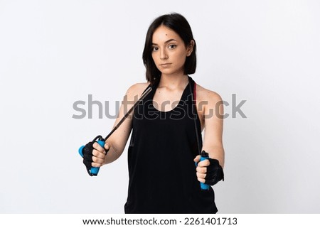 Young caucasian woman isolated on white background with jumping rope