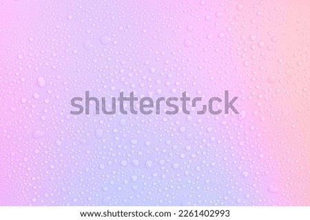 drops on a pastel multi-colored iridescent background Royalty-Free Stock Photo #2261402993