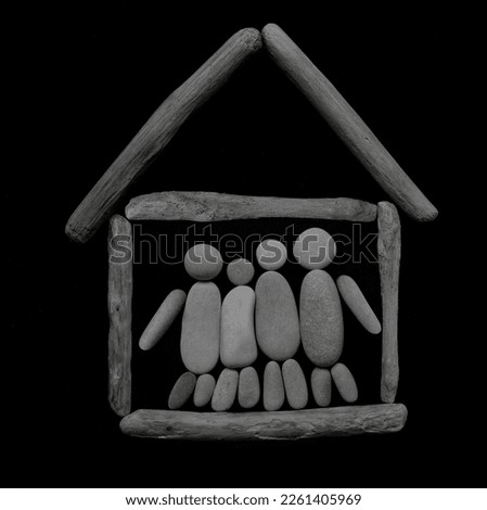 family of four people inside wooden house. group meeting, collaboration. Happy three friends. family embrace together. symbol made from many pebbles. grey stones in the form of kid, father and mother