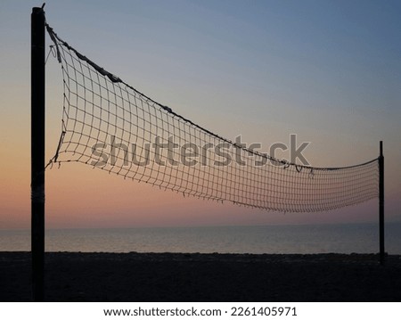 beach volleyball net in Batumi, Georgia. sunset light. Black Sea. sandy beach and sunrise. Silhouette of beach against sky during sunset. 