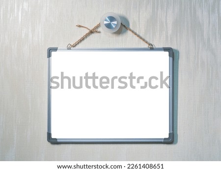 Decorative blackboard, with copy space for text, hanging on a rope on a wall with wallpaper. Mockup for design. Vacant poster.