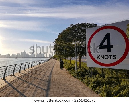 DUBAI, UAE - CIRCA 2022: Maritime speed sign on Dubai water chanel with city scape in the background