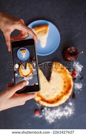 Woman hands taking a photo of a delicious cheesecake she is about to eat