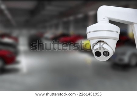 CCTV Camera Operating in car park building. Copy space