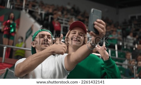 Cute fans couple take selfie photo sport soccer stadium. Happy emotion lovers enjoy romantic love date. Smile guy man win football bet. Romance joy together. Fun girl shot selfies blog mobile phone.