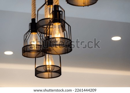 Vintage lamp hanging from the ceiling with white wall decorated in hotel Royalty-Free Stock Photo #2261444209