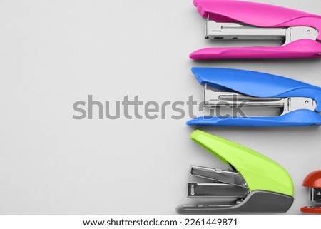 New bright staplers on white background, flat lay. Space for text