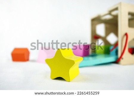 Wooden toy with pieces. Star in the center Royalty-Free Stock Photo #2261455259