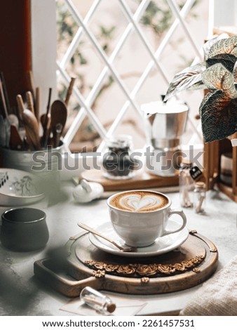 A cup of coffee besides the window. Morning coffee situations. Conceptual stilllife in brightmood photography