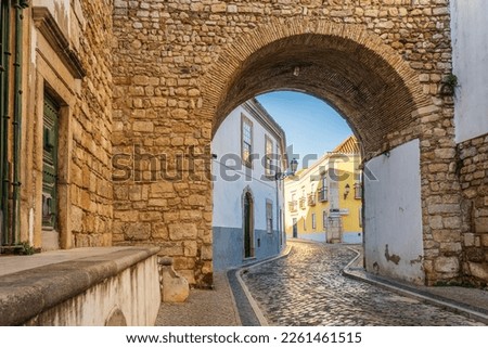 Resting Arch in medieval walls is one of 4 entrances to the old town in Faro, Algarve, Portugal  Royalty-Free Stock Photo #2261461515