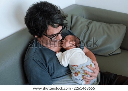 Father holds his newborn son in his arms in the maternity hospital Royalty-Free Stock Photo #2261468655