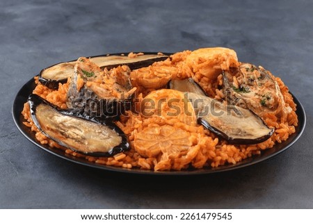 A traditional dish from Senegal, also consumed in Guinea-Bissau, Guinea, Mali, Mauritania and Gambia. This is the national dish in Senegal. Prepared with fish, rice and tomato sauce cooked in one pot. Royalty-Free Stock Photo #2261479545