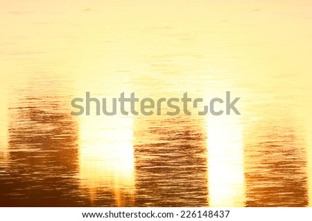 Sunlight and skyscraper reflection on the water surface of river.