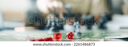 Role playing tabletop and board game hobby concept. Dice place on character sheets for create begin fantasy and adventure blur book and miniatures. Banner size background.