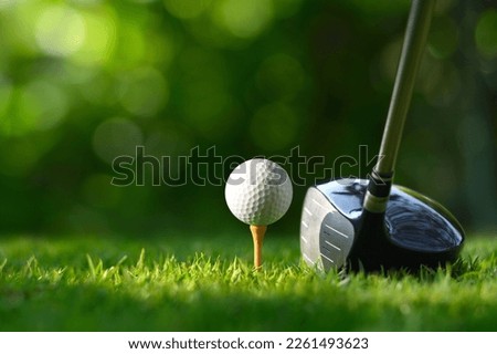 Close-up golf ball on tee with golf drivers at golf course. Royalty-Free Stock Photo #2261493623