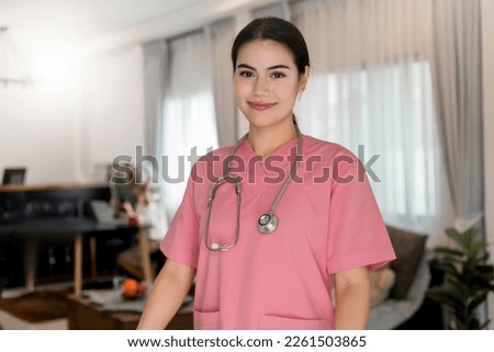 Young processional Caucasian Geriatric doctor in pink scrubs with stethoscope roll wheelchair. Physician in hospital nursing home or wellbeing county. Happy caregiver taking care of elderly people. Royalty-Free Stock Photo #2261503865