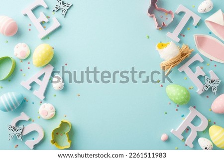 Top view photo of letters word easter colorful eggs bunny ears paws baking molds chicken in nest butterflies and sprinkles on isolated pastel blue background with copyspace