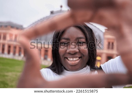 happy african american woman making a frame with her hands
