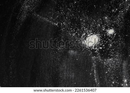 White powder splash burst on the black background top view. abstract flour powder

