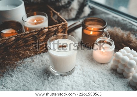 Candle with soy wax and wooden wick handmade in home interior. Royalty-Free Stock Photo #2261538565