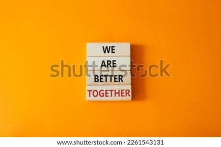 We are stronger together symbol. Wooden blocks with words We are stronger together. Beautiful orange background. We are stronger together concept. Copy space.