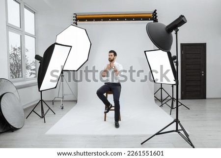 Handsome model posing in modern studio. Professional photo session