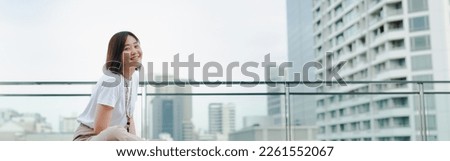 web banner solo asian woman outdoor break and relax with smile and happy feeling at rooftop with city background