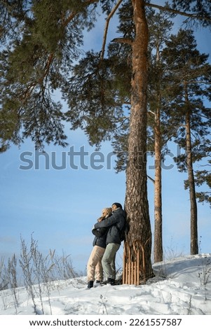 Young couple in love hugging in the winter forest and having fun spending time together.Winter, Valentine's day, newlyweds, tenderness and love. High quality photo