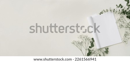 Blank magazine with floral decor on white background with space for text