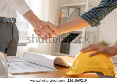 Construction worker team hands shaking greeting start up plan new project contract in office center at construction site, industry ,architecture, partner, teamwork, agreement, property, contacts. Royalty-Free Stock Photo #2261569219