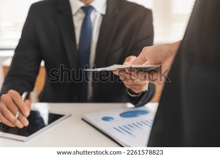 Good job, asian manager man giving financial reward in an envelope, business letter extra salary to company employee, caucasian male worker office hand received premium bonus, getting cheque from boss Royalty-Free Stock Photo #2261578823