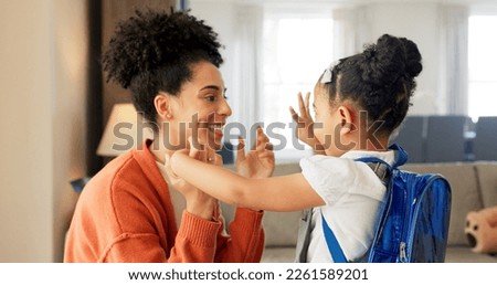 Little girl kissing her mother. Young mother hugging her daughter. Loving mother hugging daughter before school outside. Little girl going to school. Happy woman embracing daughter