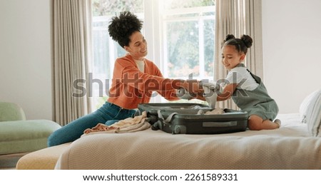 Travel, luggage and mom packing with child in bedroom getting ready for trip. Helping hands, black family and young girl help mother pack clothes in suitcase for holiday, vacation and weekend away Royalty-Free Stock Photo #2261589331