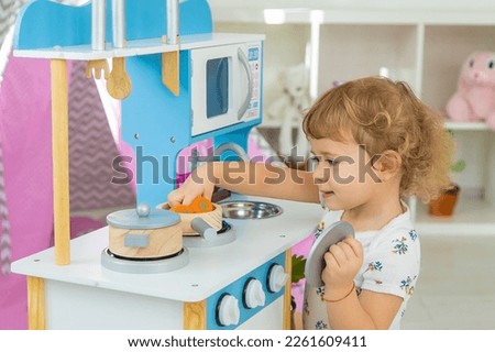 the child plays in the kitchen and cooks. Selective focus. Kid. Royalty-Free Stock Photo #2261609411