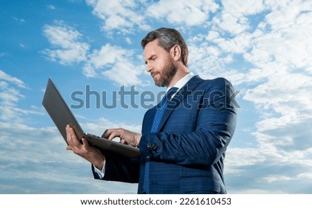 freelancer man work on laptop wearing suit. photo of freelancer man with laptop.
