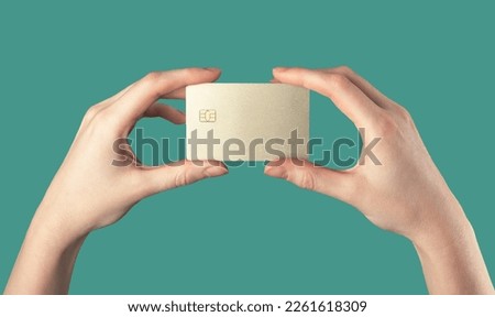 Bank credit debit card mockup, gold sample hands. Plastic bankcard with chip for ad, promo. High quality photo Royalty-Free Stock Photo #2261618309