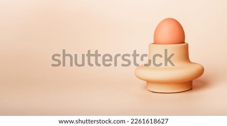 Natural unpainted undyed chicken egg in holder, cup. Banner background with copy space for text. High quality photo