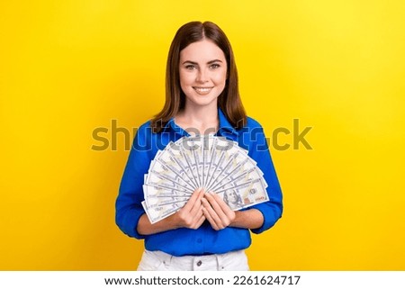 Photo of positive cute ukrainian lady office manager get salary demonstrate usd paper banknotes isolated on yellow color background