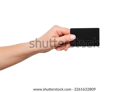 Close up of womans hand holding blank black card Royalty-Free Stock Photo #2261632809